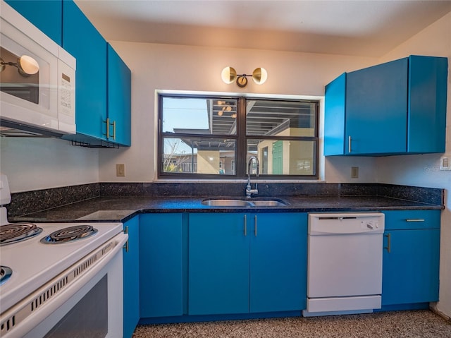 kitchen with white appliances, dark stone counters, blue cabinets, and sink