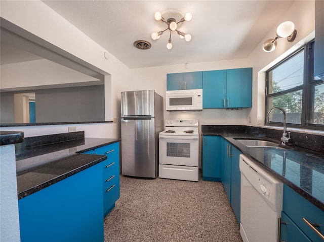 kitchen with white appliances, dark stone countertops, blue cabinetry, and sink