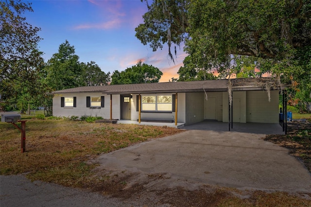 ranch-style home with a carport and a yard