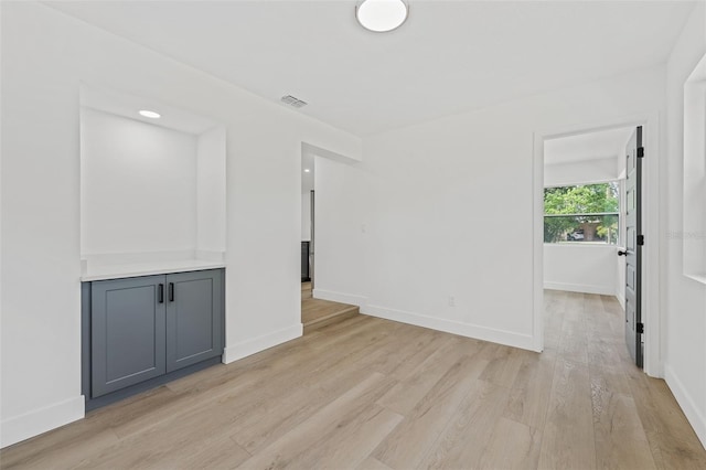 empty room with light hardwood / wood-style flooring