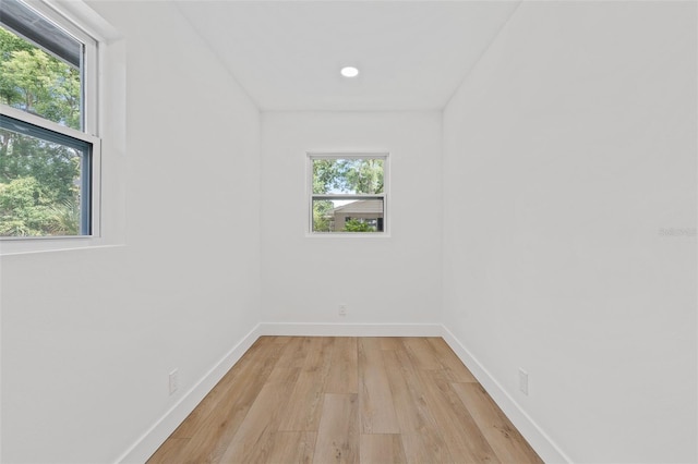 empty room with light wood-type flooring and a healthy amount of sunlight