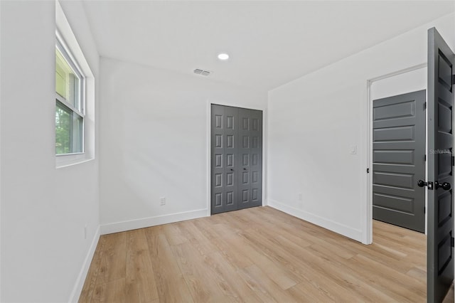 unfurnished room with light wood-type flooring