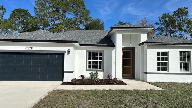 view of front facade featuring a garage and a front lawn