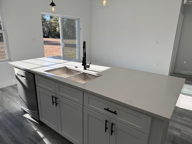 kitchen featuring gray cabinets, pendant lighting, sink, black dishwasher, and a kitchen island with sink