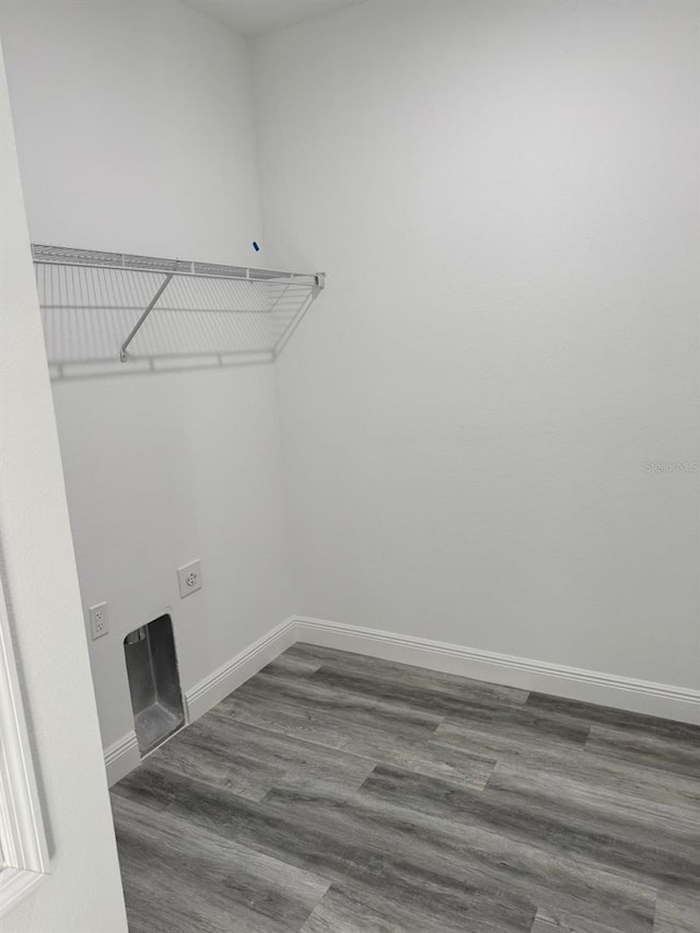 washroom featuring dark wood-type flooring and electric dryer hookup