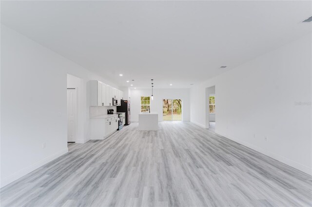 unfurnished living room with light wood-type flooring