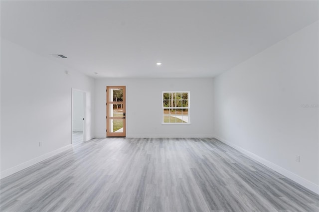 spare room with light wood-type flooring