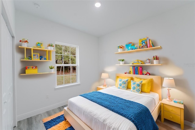 bedroom with hardwood / wood-style floors