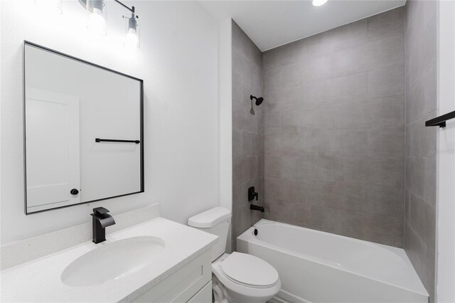 full bathroom with tiled shower / bath combo, vanity, and toilet