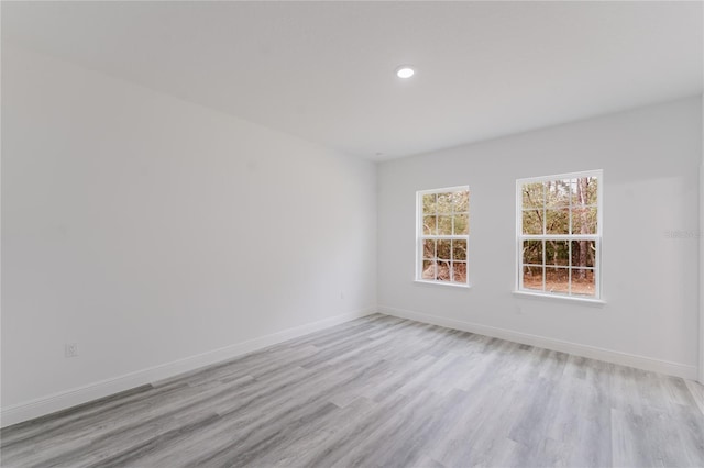 unfurnished room with light hardwood / wood-style flooring