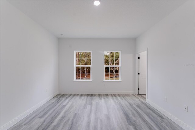 unfurnished room with light wood-type flooring