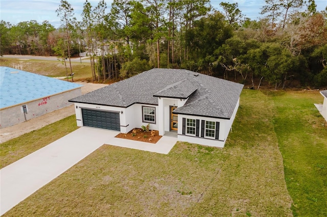 view of front of home with a garage and a front yard