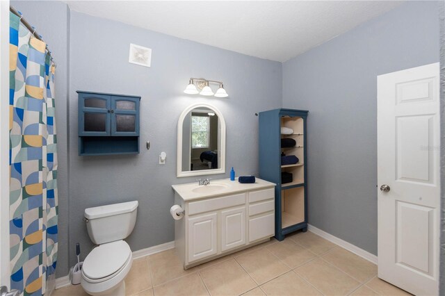 1351 Venezia Ct Unit 304, Davenport, FL 33896 - full bath with tile patterned floors, toilet, baseboards, curtained shower, and vanity