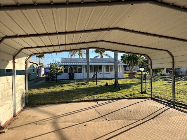 view of parking / parking lot with a carport and a lawn