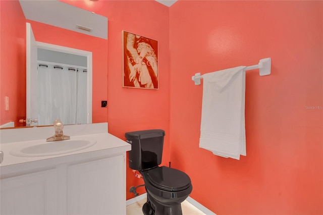 bathroom with vanity and toilet