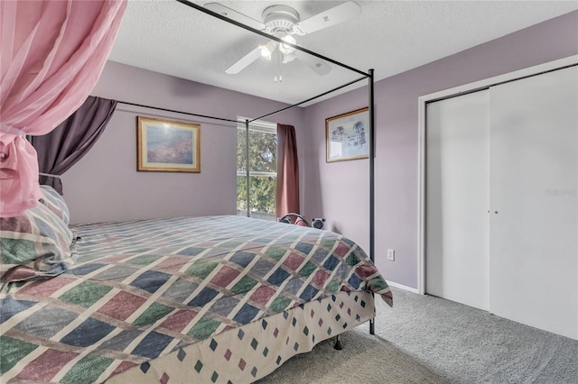 carpeted bedroom with ceiling fan, a closet, and a textured ceiling