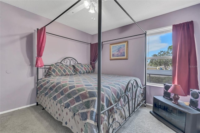 bedroom with carpet, ceiling fan, and a textured ceiling