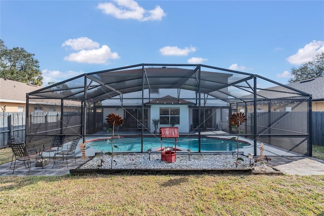 view of pool with a lawn and glass enclosure