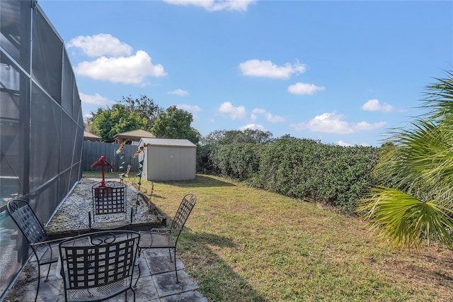 view of yard with a patio and a storage unit