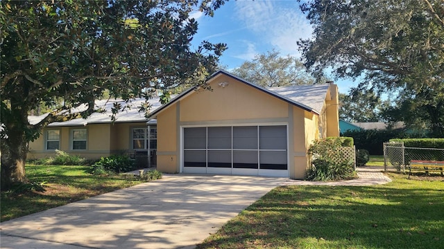 single story home featuring a garage and a front yard