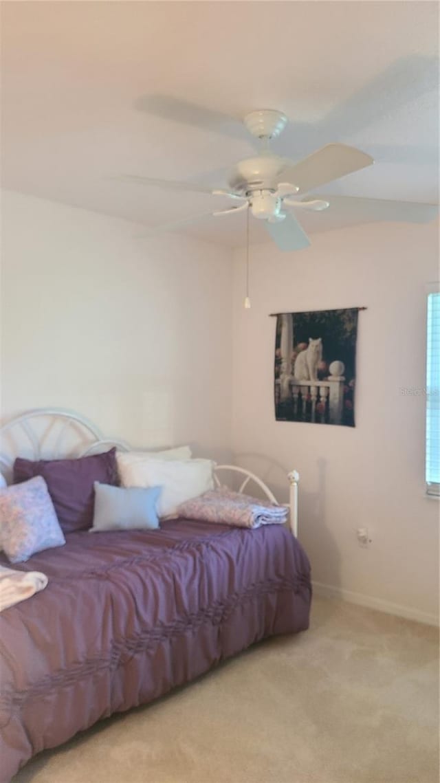 bedroom featuring ceiling fan and light carpet