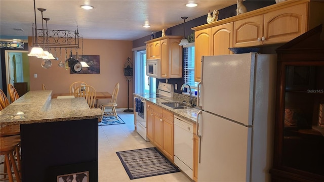 kitchen featuring sink, light brown cabinets, pendant lighting, white appliances, and light tile patterned flooring