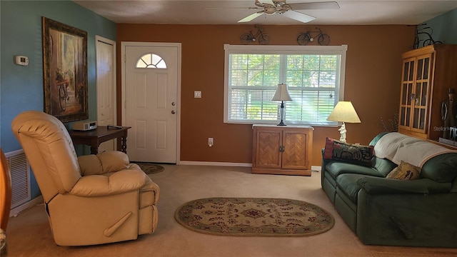 living room with ceiling fan and light colored carpet