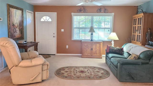 carpeted living room with ceiling fan