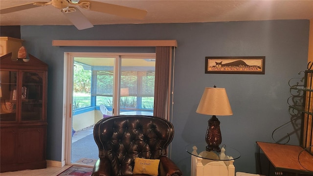 living area featuring ceiling fan