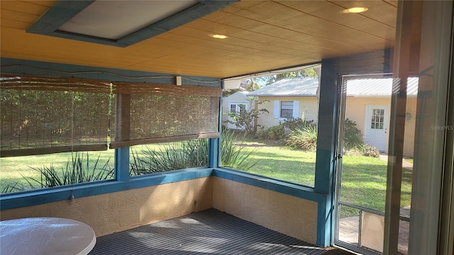 unfurnished sunroom featuring wooden ceiling