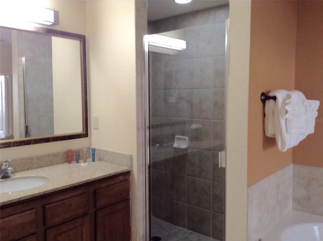 bathroom with plus walk in shower, vanity, and an AC wall unit