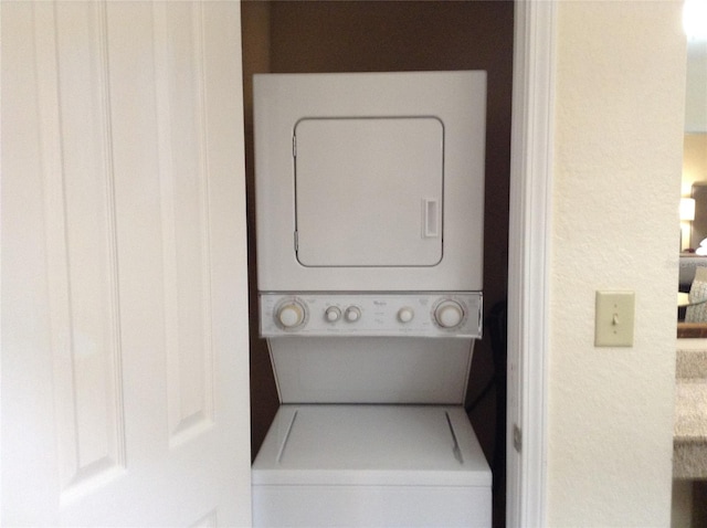 washroom with stacked washer / dryer