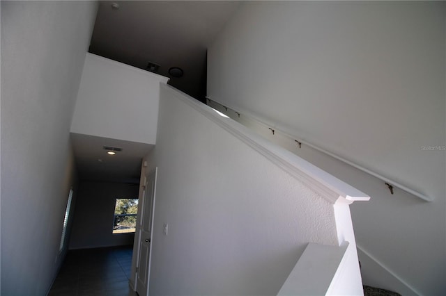 staircase featuring tile patterned flooring