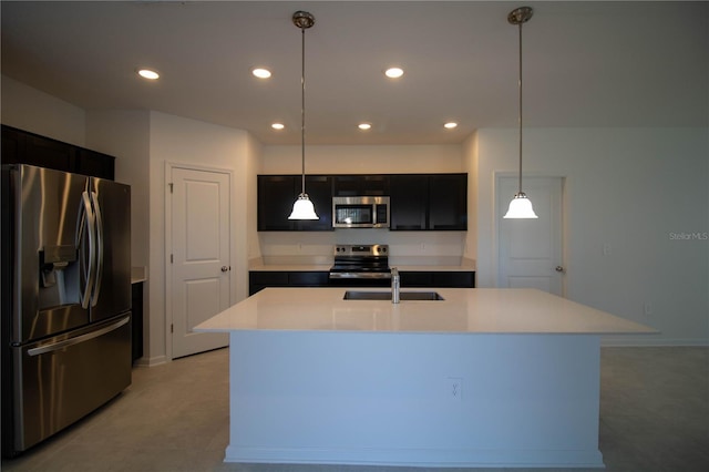 kitchen with stainless steel appliances, hanging light fixtures, a center island with sink, and sink