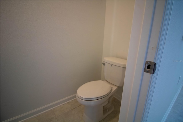 bathroom with tile patterned flooring and toilet