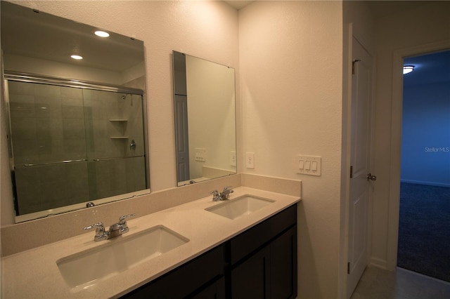 bathroom featuring vanity and a shower with shower door