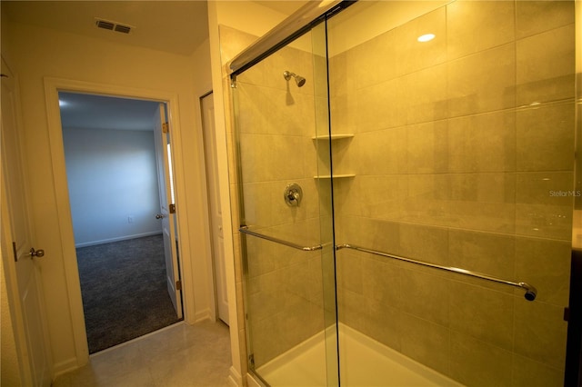 bathroom featuring a shower with shower door