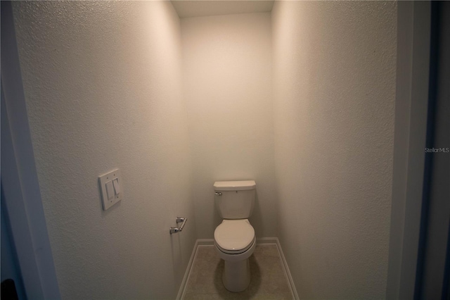 bathroom featuring tile patterned flooring and toilet