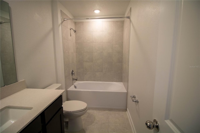 full bathroom with tile patterned floors, vanity, tiled shower / bath, and toilet