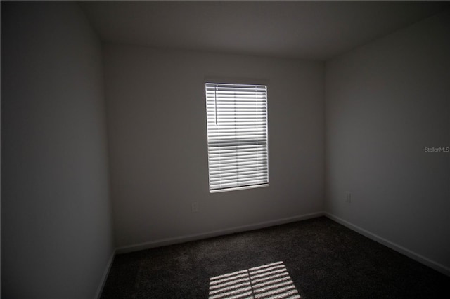 empty room with dark carpet