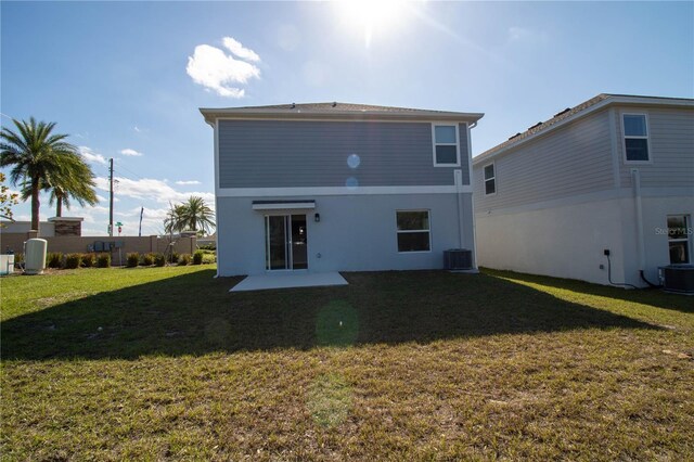 back of house with a lawn and cooling unit