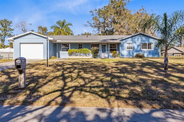 single story home featuring a front lawn and a garage