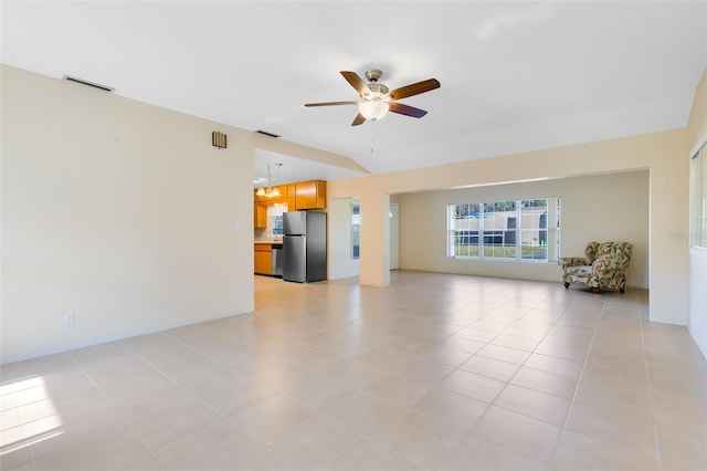 unfurnished living room with light tile patterned flooring and ceiling fan