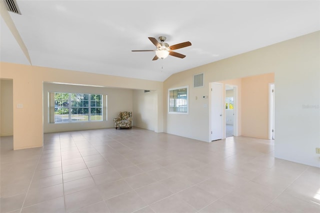 unfurnished room with vaulted ceiling, ceiling fan, and light tile patterned floors