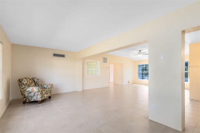 living area with light tile patterned flooring and ceiling fan