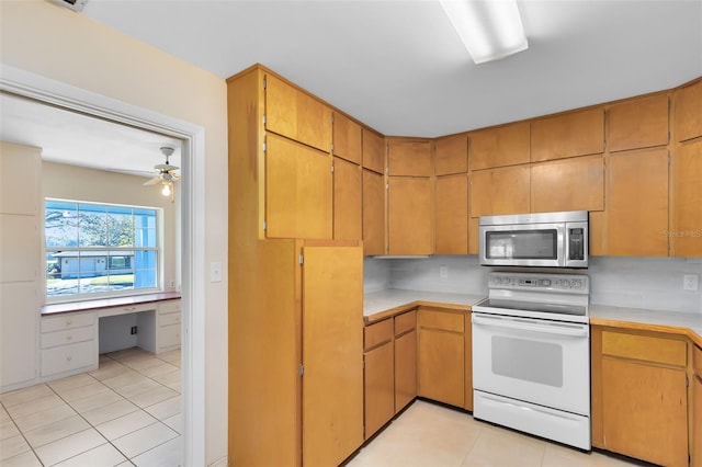 kitchen featuring backsplash, electric range, light tile patterned floors, and ceiling fan