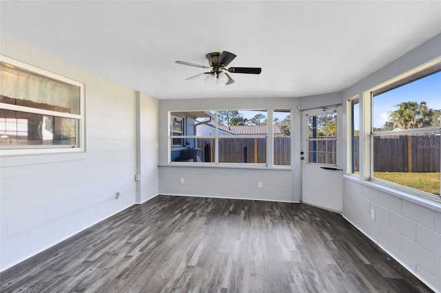 unfurnished sunroom featuring ceiling fan