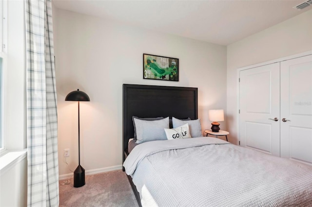 carpeted bedroom featuring a closet