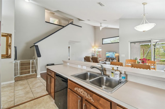 kitchen featuring light tile patterned floors, black dishwasher, lofted ceiling, pendant lighting, and sink