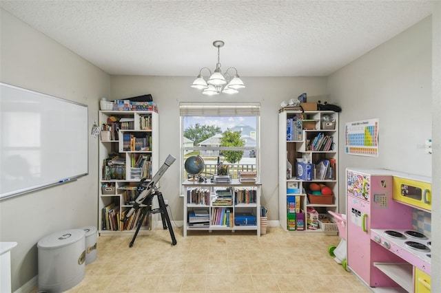 miscellaneous room with a textured ceiling and a notable chandelier